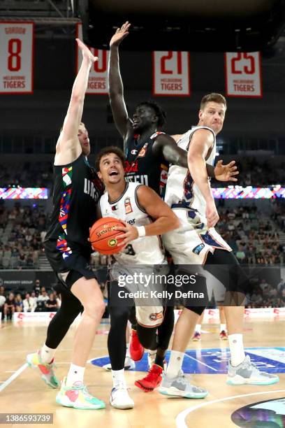 Dusty Hannahs of the 36ers dribbles the ball against Jack White of United and Jo Lual-Acuil of United during the round 16 NBL match between Melbourne...