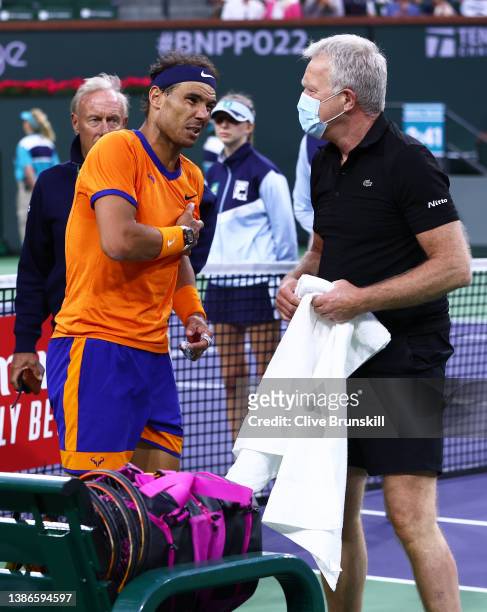 Rafael Nadal of Spain speaks to the ATP trainer Per Bastholt about his injury at the change over against Carlos Alcaraz of Spain in their semifinal...