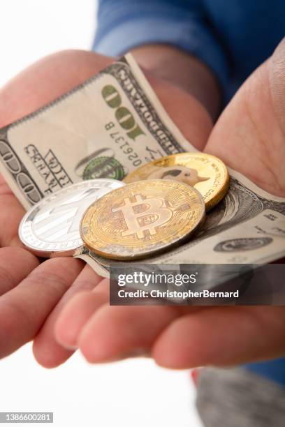 cryptocurrency and us currency in palm of hand - coin in palm of hand stock pictures, royalty-free photos & images