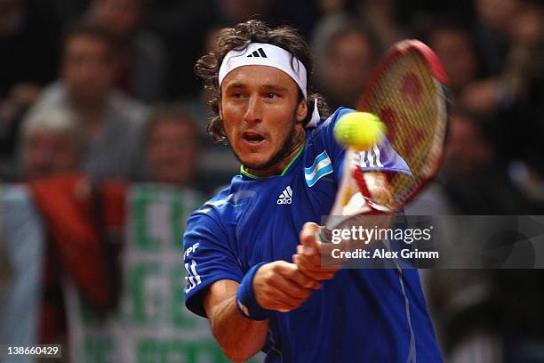 Juan Monaco of Argentina returns the ball to Philipp Petzschner of Germany on day 1 of the Davis Cup World Group first round match between Germany...