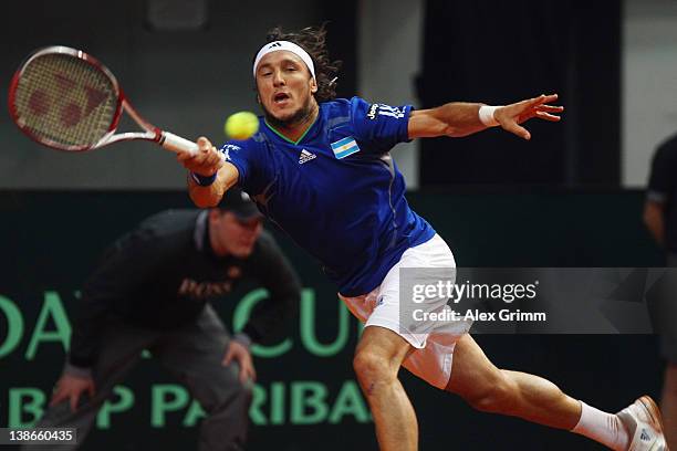 Juan Monaco of Argentina returns the ball to Philipp Petzschner of Germany on day 1 of the Davis Cup World Group first round match between Germany...