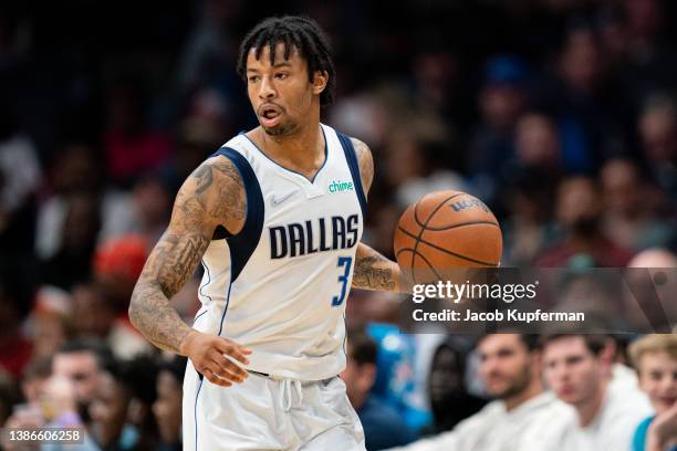 Trey Burke of the Dallas Mavericks brings the ball up court against the Charlotte Hornets during their game at Spectrum Center on March 19, 2022 in...