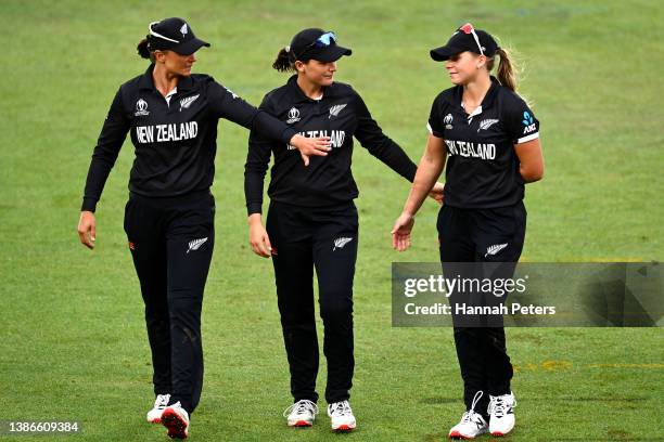 Suzie Bates, Amelia Kerr and Jess Kerr of New Zealand leave the field after losing the 2022 ICC Women's Cricket World Cup match between New Zealand...