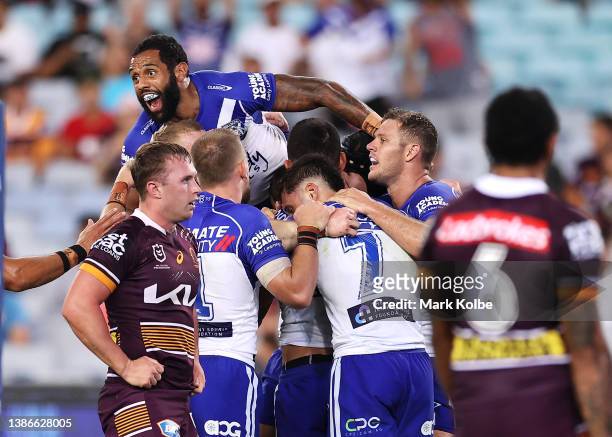 Josh Addo-Carr of the Bulldogs jumps on the pack as Jeremy Marshall-King of the Bulldogs celebrates with his team mates after scoring a try during...