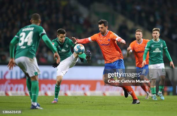 Ilia Gruev of Werder Bremen is challenged by Luca Pfeiffer of SV Darmstadt 98 during the Second Bundesliga match between SV Werder Bremen and SV...