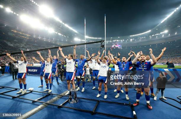Captain Antoine Dupont of France and teammates celebrate winning the Grand Slam during the trophy ceremony following the Guiness Six Nations Rugby...