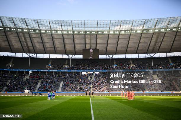 Players, officals and fans take part in a minute of silence concerning the formerly DFB president Egidius Braun prior to the Bundesliga match between...