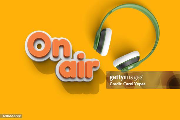on air red 3d letters with headphones made of paper work.yellow background - abc broadcasting company stock-fotos und bilder