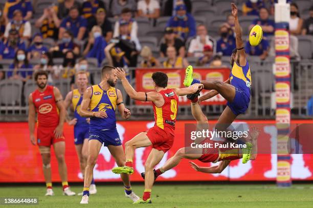 Willie Rioli of the Eagles collides with Matt Rowell of the Suns in a marking contest during the round one AFL match between the West Coast Eagles...