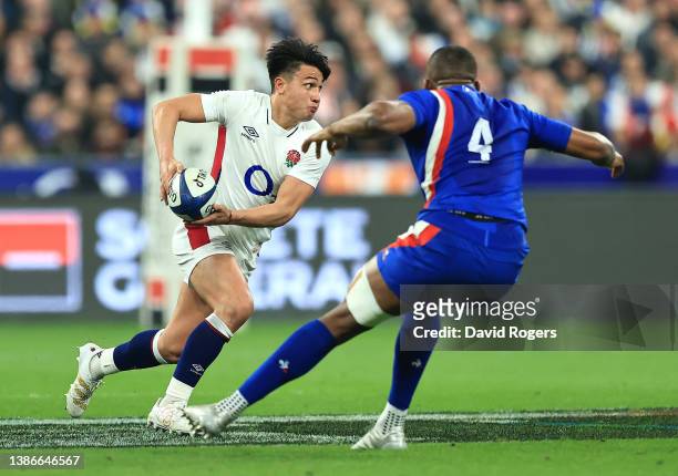 Marcus Smith of England takes on Cameron Woki during the Guinness Six Nations Rugby match between France and England at the Stade de France on March...
