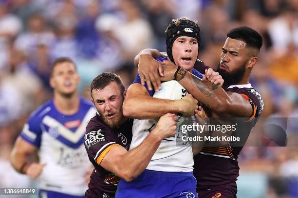 Matt Burton of the Bulldogs is tackled during the round two NRL match between the Canterbury Bulldogs and the Brisbane Broncos at Accor Stadium, on...