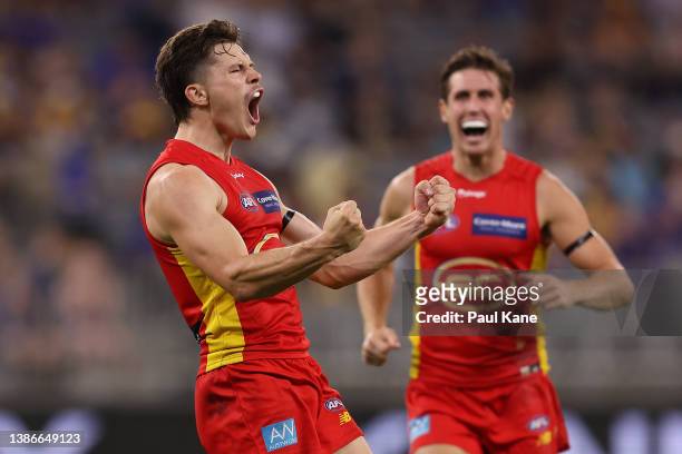 Ben Ainsworth of the Suns celebrates a goal during the round one AFL match between the West Coast Eagles and the Gold Coast Suns at Optus Stadium on...