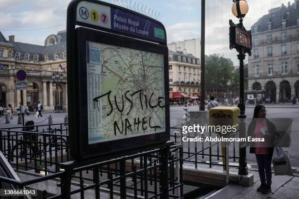 Justice Nahel" is scrawled the Palais Royal Musee du Louvre metro sign on July 2, 2023 in Paris, France. Last night demonstrators took to the streets...