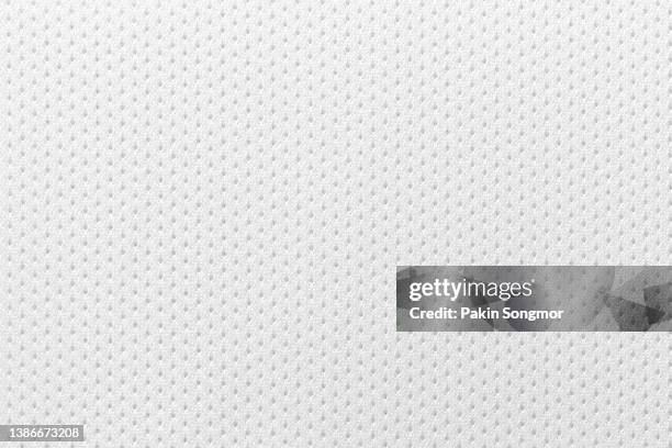 fabric for sports clothing in a white color, the texture of a football shirt jersey, and a textile background - monochrome clothing stock-fotos und bilder