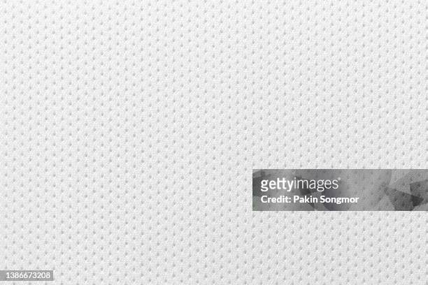 fabric for sports clothing in a white color, the texture of a football shirt jersey, and a textile background - polyester fotografías e imágenes de stock
