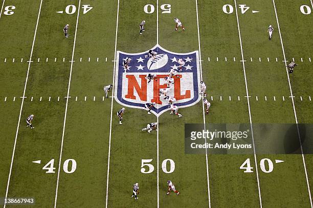 Eli Manning of the New York Giants lines the offense up in the shotgun formation against the New England Patriots during Super Bowl XLVI at Lucas Oil...