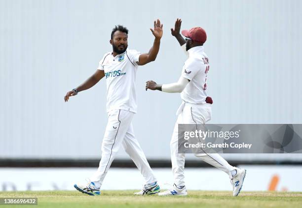 Veerasammy Permaul of the West Indies celebrates with Jermaine Blackwood after dismissing Joe Root of England during day five of the 2nd test match...