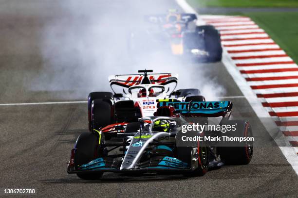 Lewis Hamilton of Great Britain driving the Mercedes AMG Petronas F1 Team W13 leads Kevin Magnussen of Denmark driving the Haas F1 VF-22 Ferrari who...