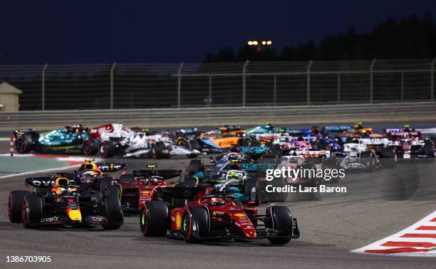 Charles Leclerc of Monaco driving the Ferrari F1-75 leads Max Verstappen of the Netherlands driving the Oracle Red Bull Racing RB18 and the rest of...