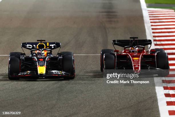 Max Verstappen of the Netherlands driving the Oracle Red Bull Racing RB18 and Charles Leclerc of Monaco driving the Ferrari F1-75 battle for track...