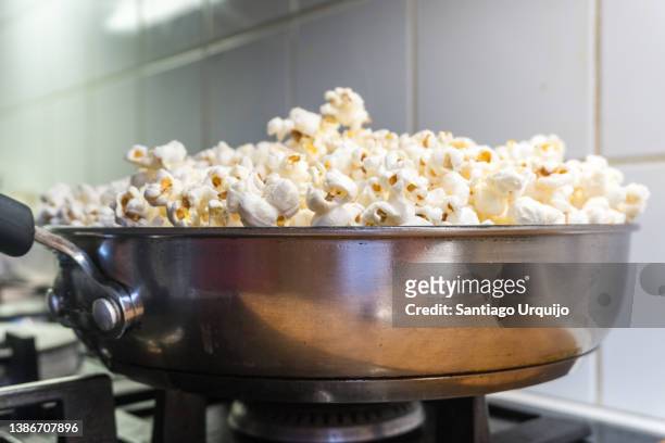 close-up of popcorn being made on a cooking pot - popcorn full frame stock pictures, royalty-free photos & images