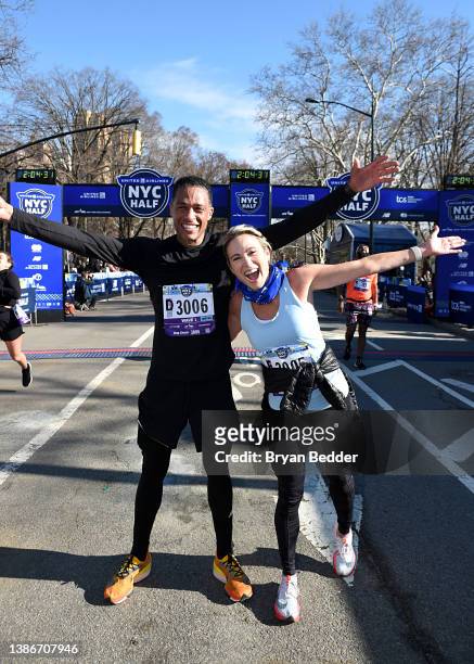 Holmes and Amy Robach celebrate as they cross the finish line during the 2022 United Airlines NYC Half Marathon on March 20, 2022 in New York City.