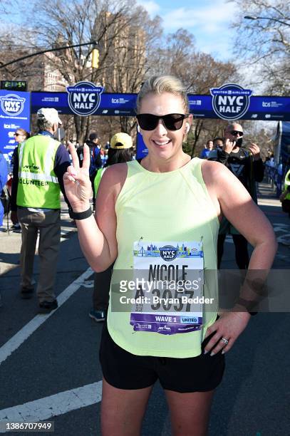 Nicole Briscoe celebrates as she crosses the finish line during the 2022 United Airlines NYC Half Marathon on March 20, 2022 in New York City.