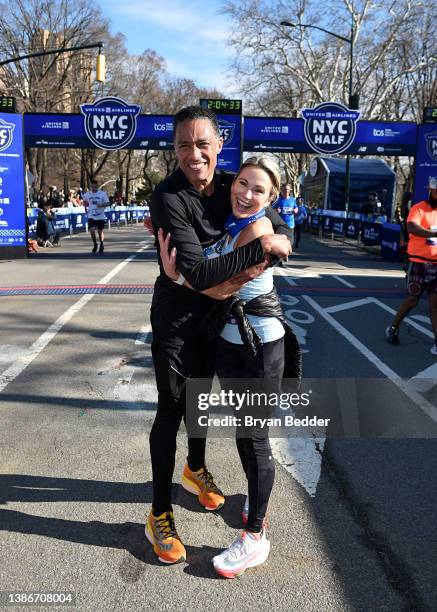 Holmes and Amy Robach celebrate as they cross the finish line during the 2022 United Airlines NYC Half Marathon on March 20, 2022 in New York City.