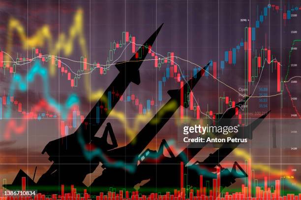 missiles on the background of stock charts. economic crisis due to war - ukraine war fotografías e imágenes de stock