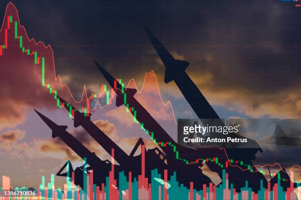 missiles on the background of stock charts. economic crisis due to war - ukraine crisis stock-fotos und bilder