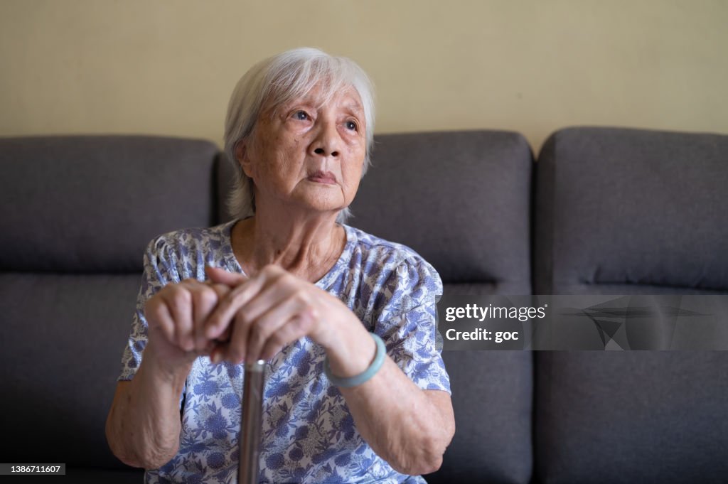Elderly woman with walking stick