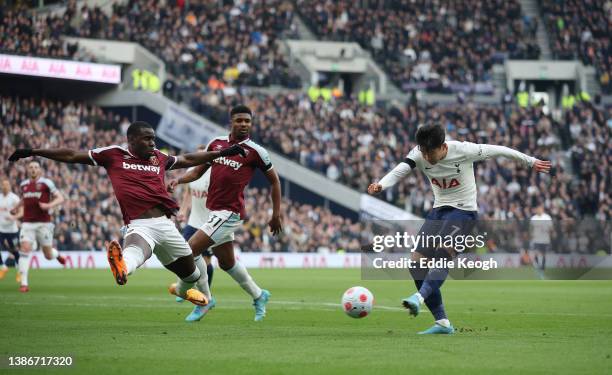 Heung-Min Son of Tottenham Hotspur scores their side's second goal whilst under pressure from Kurt Zouma of West Ham United during the Premier League...