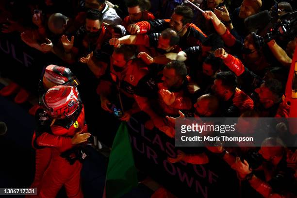 Race winner Charles Leclerc of Monaco and Ferrari and Second placed Carlos Sainz of Spain and Ferrari celebrate with their team in parc ferme during...