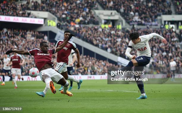 Heung-Min Son of Tottenham Hotspur scores their side's second goal whilst under pressure from Kurt Zouma of West Ham United during the Premier League...