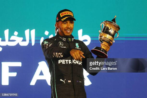 Third placed Lewis Hamilton of Great Britain and Mercedes celebrates on the podium during the F1 Grand Prix of Bahrain at Bahrain International...