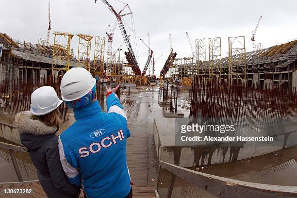 Volunteers stand on the ground of the construction site of the Olympic stadium "Fisht" on February 10, 2012 in Sochi, Russia. The "Fisht" will host...