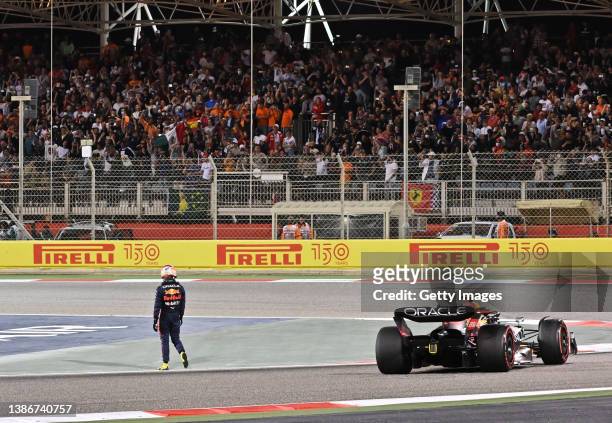 Sergio Perez of Mexico and Oracle Red Bull Racing walks from his car after retiring from the race during the F1 Grand Prix of Bahrain at Bahrain...