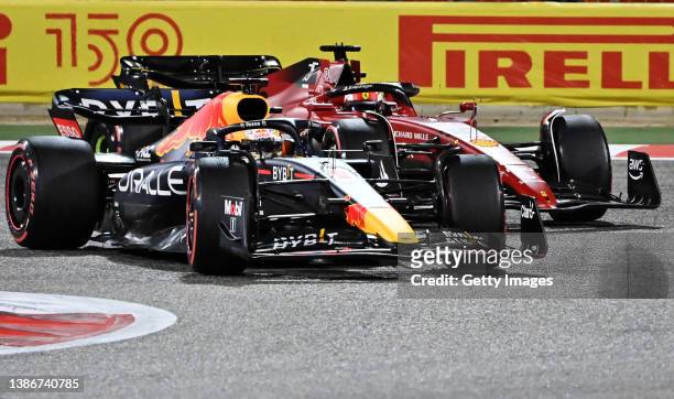 Max Verstappen of the Netherlands driving the Oracle Red Bull Racing RB18 overtakes Charles Leclerc of Monaco driving the Ferrari F1-75 during the F1...