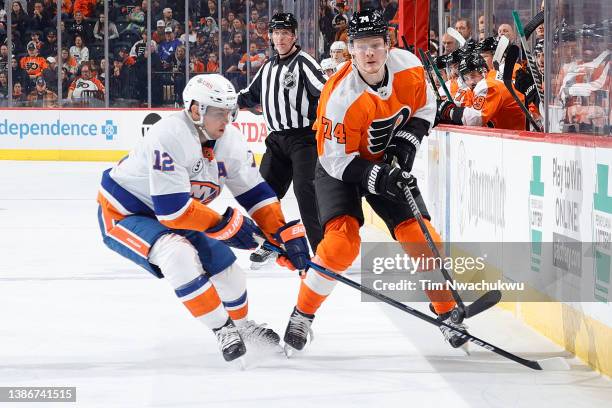 Josh Bailey of the New York Islanders and Owen Tippett of the Philadelphia Flyers challenge for the puck during the second period at Wells Fargo...