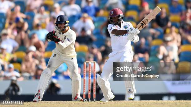 West Indies captain Kraigg Brathwaite bats watched by England wicketkeeper Ben Foakes during day five of the 2nd test match between West Indies and...
