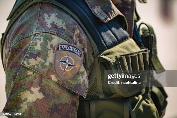 italian nato soldier attending at an italian military public event. detail of uniform. - nato forces stock pictures, royalty-free photos & images