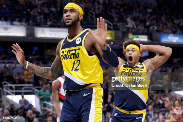 Oshae Brissett and Justin Anderson of the Indiana Pacers react after Brissett dunked the ball in the second quarter against the Portland Trail...