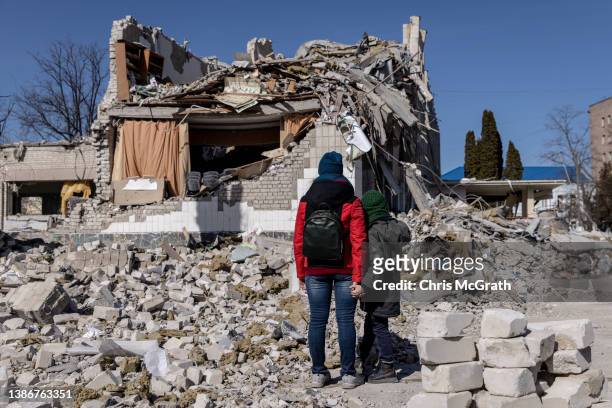 People look at damage at a school that was hit by a Russian attack ten days ago on March 20, 2022 in Zhytomyr, Ukraine. Russian forces remain on the...