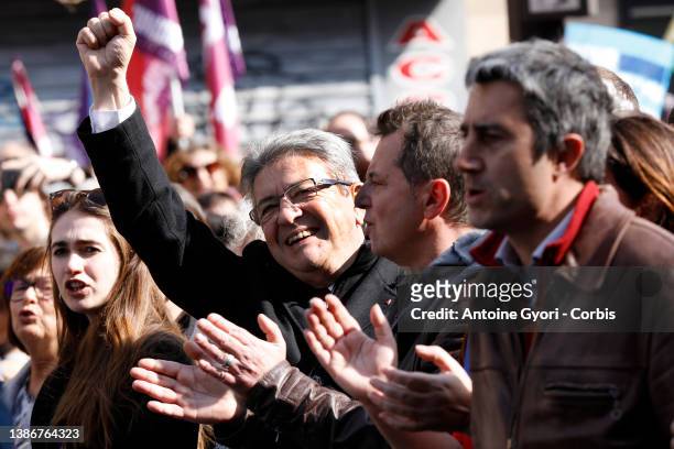 Supporters wave flags of 'La France Insoumise' presidential candidate Jean-Luc Melenchon during a parade between the Bastille and the Republic during...