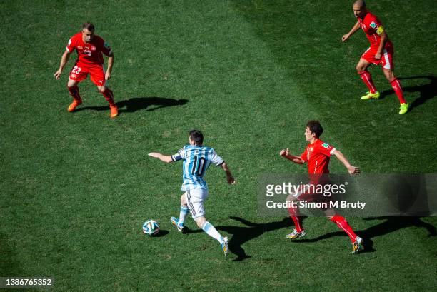 Lionel Messi of Argentina and Admir Mehmedi, Xherdan Shaquiri and Gokhan Inler of Switzerland during World Cup round of 16 match between Argentina...