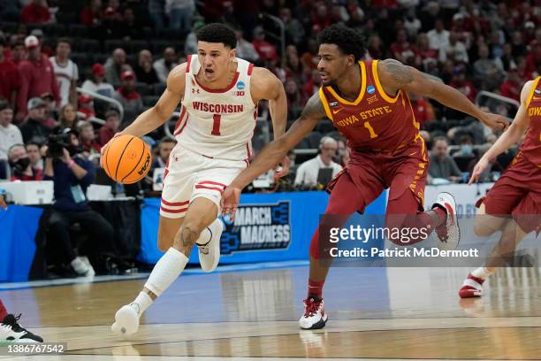 Johnny Davis of the Wisconsin Badgers dribbles the ball in front of Izaiah Brockington of the Iowa State Cyclones during the first half in the second...