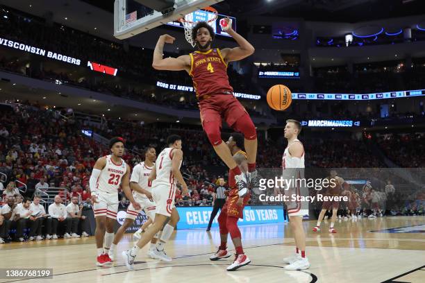 George Conditt IV of the Iowa State Cyclones reacts after dunking the ball in front of Johnny Davis of the Wisconsin Badgers during the first half in...
