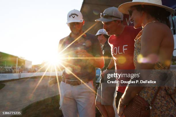 Sam Burns of the United States celebrates with his wife Caroline Campbell and Joel Dahmen of the United States after defeating Davis Riley of the...