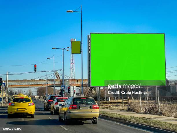 medium size green screen chroma key marketing advertisement billboard in city centre urban road freeway highway environment targeting adverts at consumers, retail shoppers, commuters and tourists as they drive past in their cars. - frankfurt international airport stock-fotos und bilder