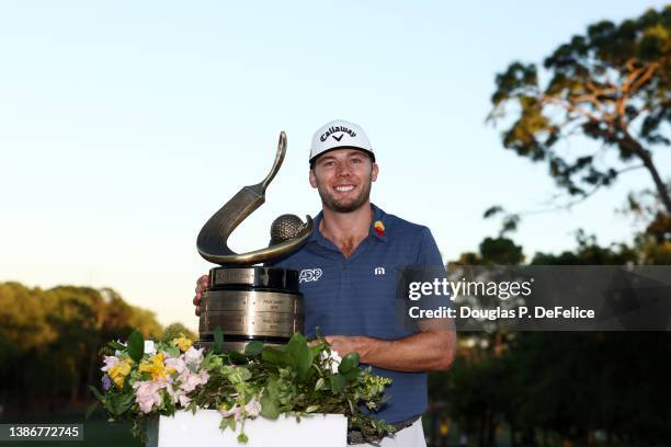 Sam Burns of the United States celebrates with the trophy after winning during a playoff in the final round of the Valspar Championship on the...